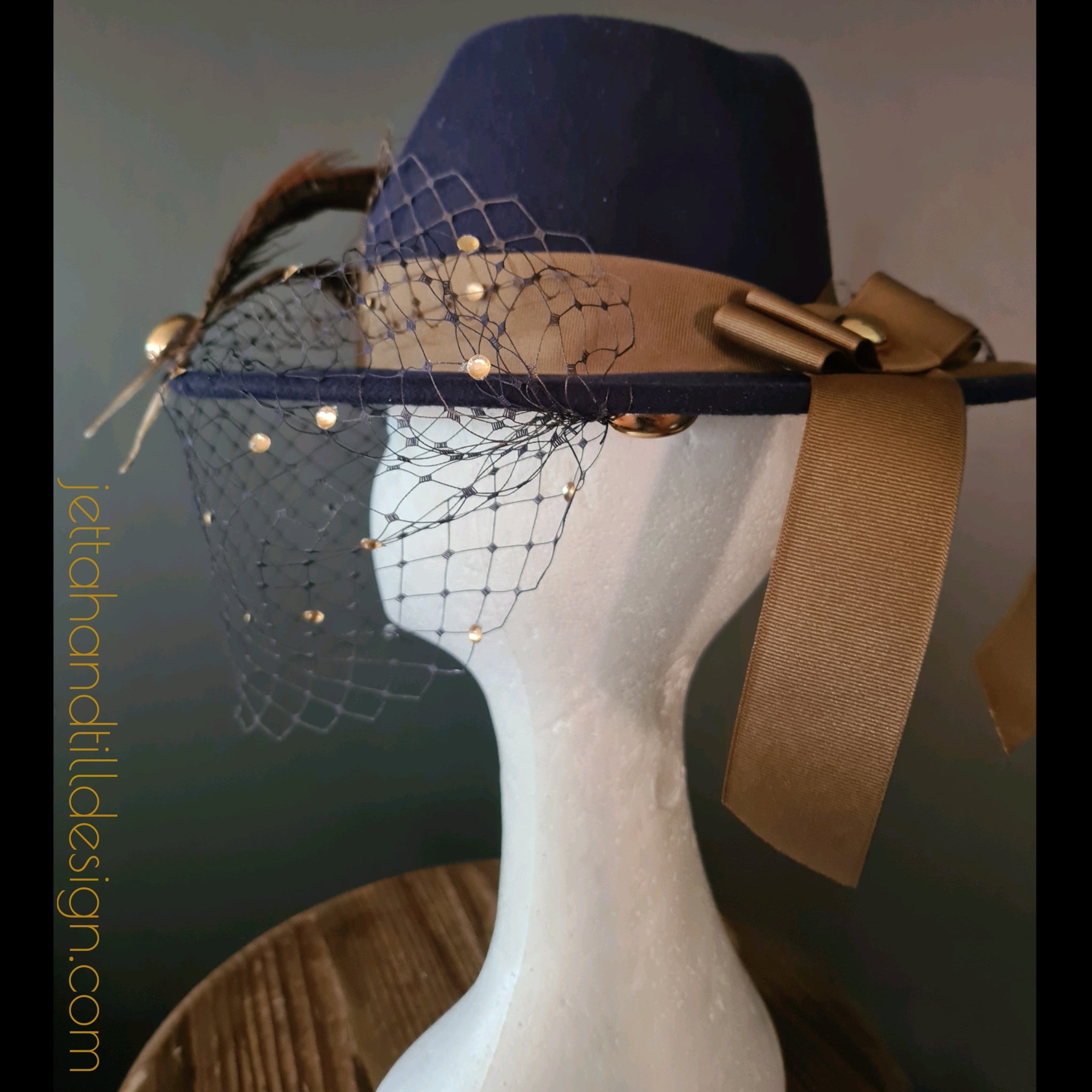 Navy felt fedora with soft brown amherst feathers and ombre navy gold diamonte veiling