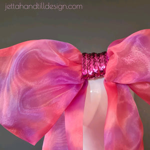 Red and purples organza bow with metallic centre