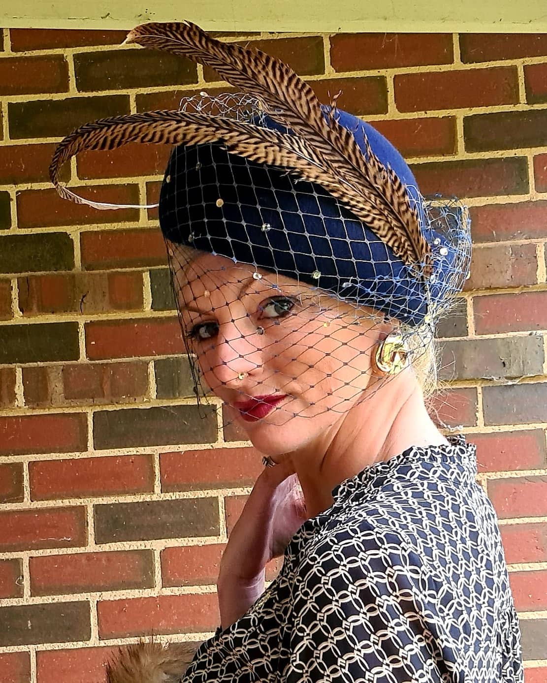 Navy felt veiled vintage blocked hat with sculpted tan feathers